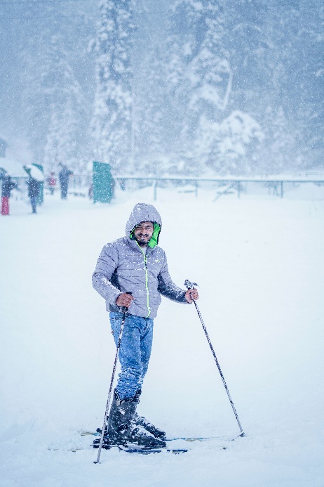 A person skiing in deep snow at a mountain resort.